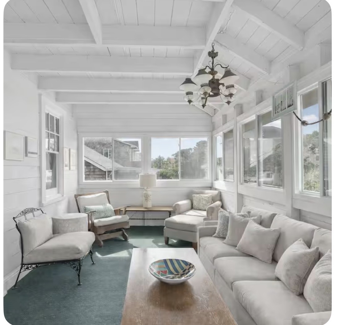Sunlit enclosed porch with comfortable seating